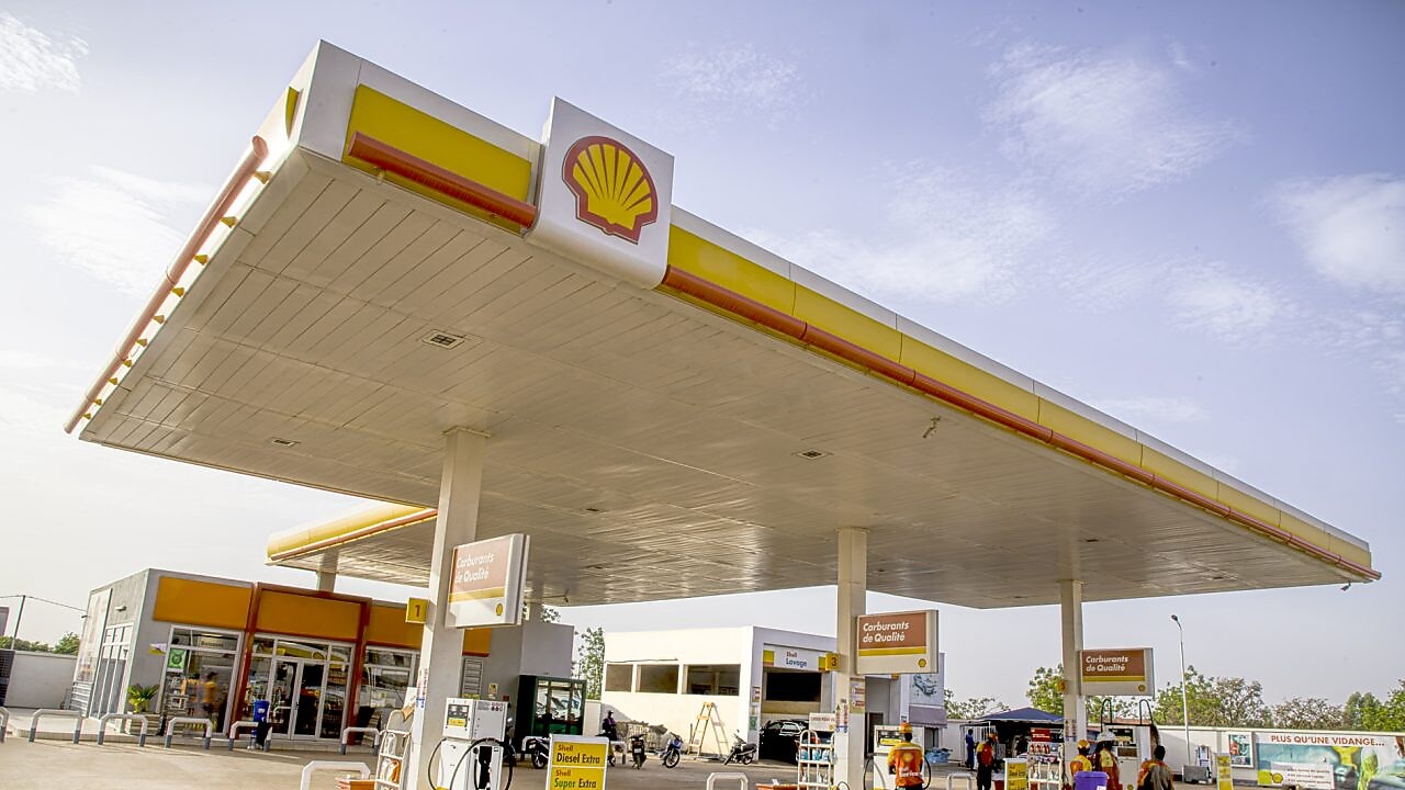 The forecourt of a shell service station at dusk