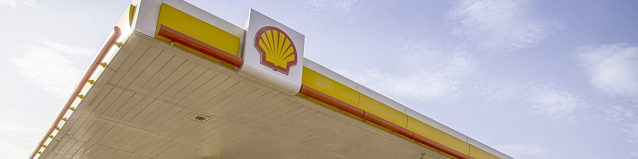 The forecourt of a shell service station at dusk