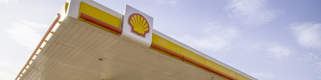 The forecourt of a shell service station at dusk