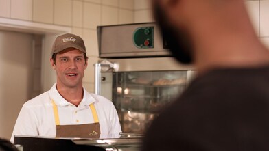 man at shop counter
