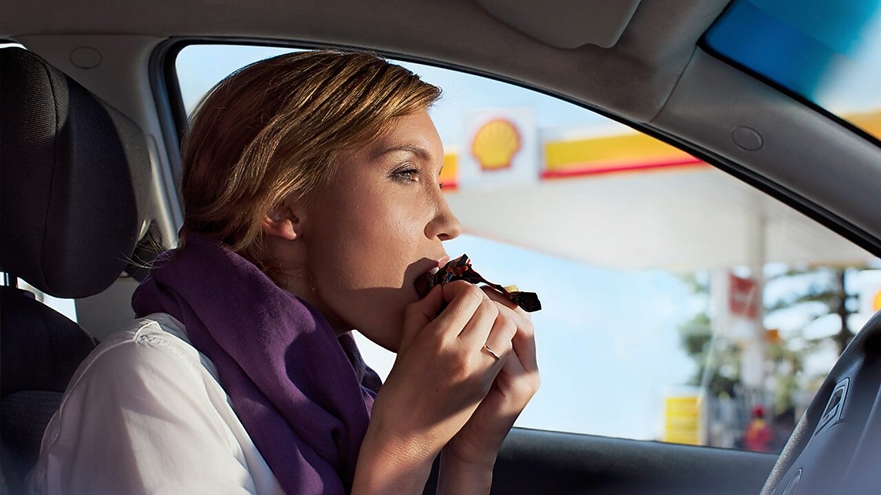 girl with purple scarf snacking