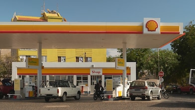 The forecourt of a shell service station at dusk