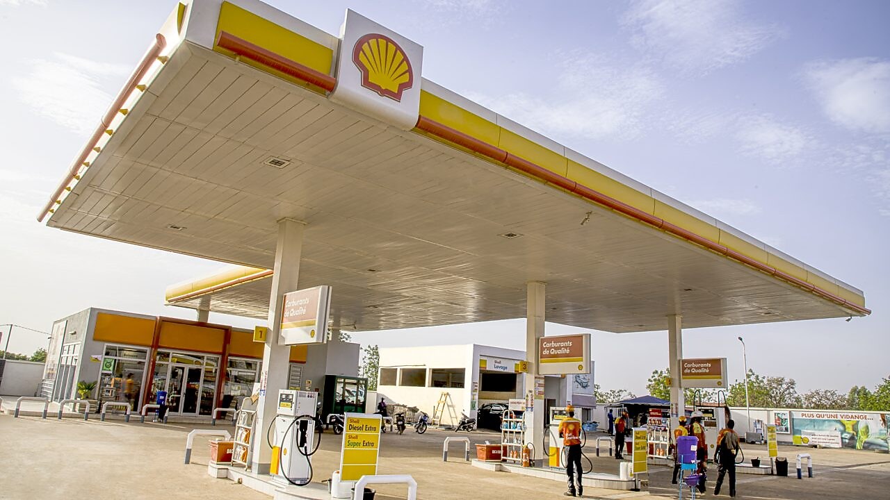 The forecourt of a shell service station at dusk